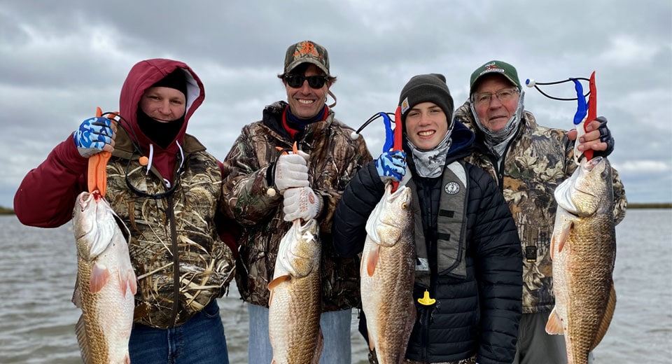 Four people with fish after an inshore fishing trip