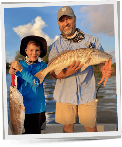captain and kid with saltwater Red Drum after fishing trip