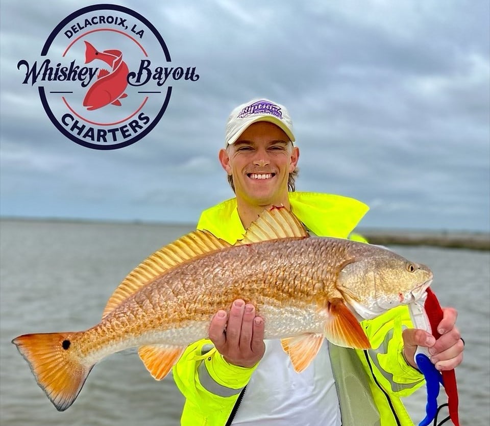 Man Holding a Red Drum on a Fishing charter