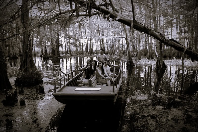 New-Orleans-Date-Night-Tours B&W Boat full of people taking a tour through the swamp.